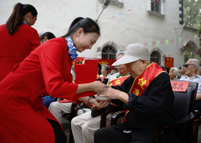 学生志愿者为健康老人敬茶